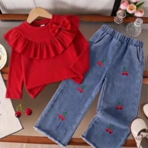 Adorable red ruffle-top with a cute bow detail, paired with cherry-embroidered denim pants. A sweet and playful outfit for little girls.